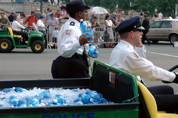 Police getting cold water bottles from motorized carts